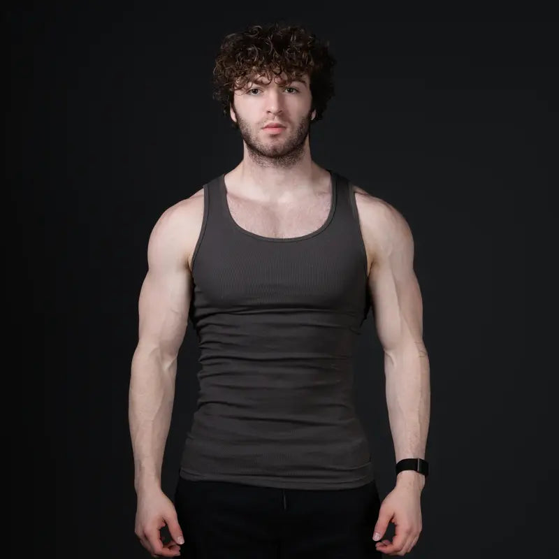 Men’s versatile tank top that smooths bulges and enhances a strong, athletic fit.